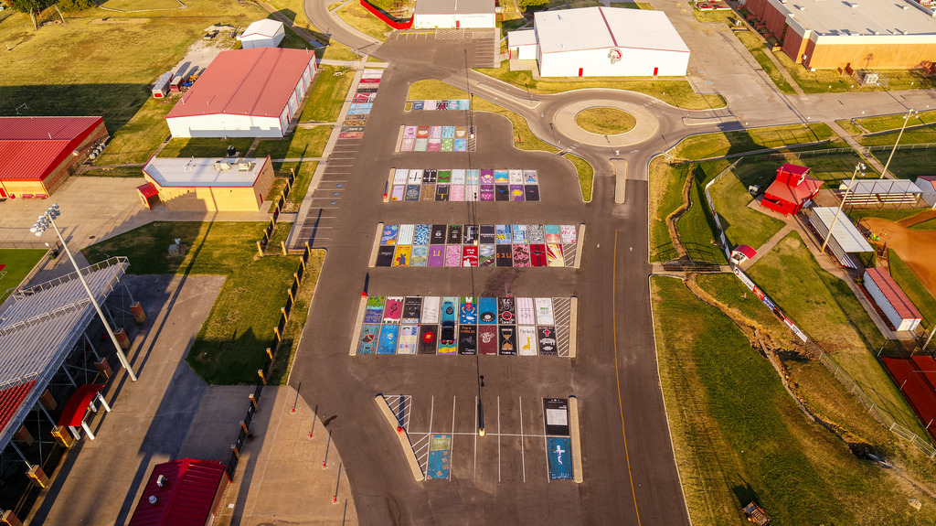 Birds eye view of student parking lot with painted parking spots.
