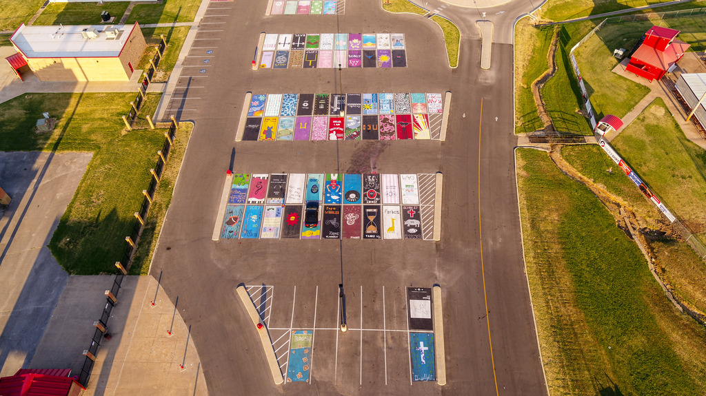 Birds eye view of student parking lot with painted parking spots.