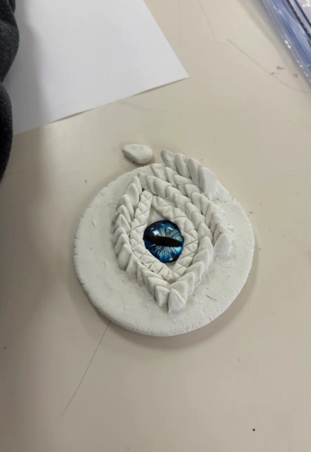 Art 1 students kicked off the year with their first clay project: imaginative dragon eye sculptures!   This hands-on project challenged students to transform a lump of clay into a three-dimensional mythical creature eye while exploring texture, craftsmanship, and creative design. It was the perfect way to spark creativity and set the tone for a year of bold, original art-making!