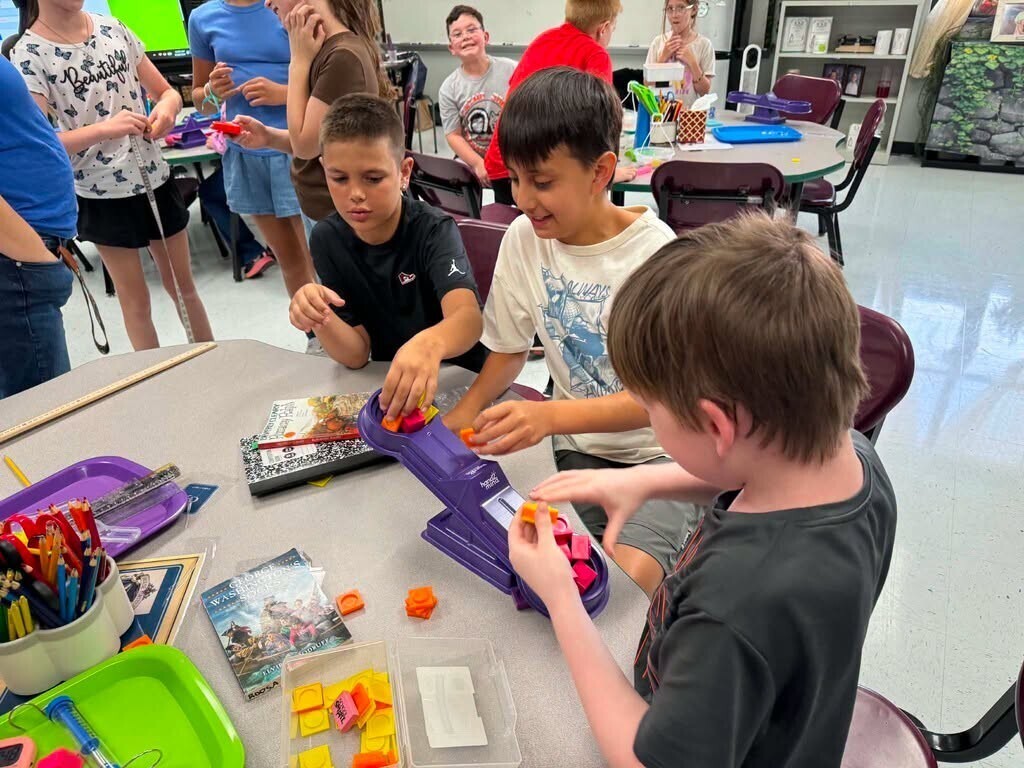 Elementary students doing science experiments in class.