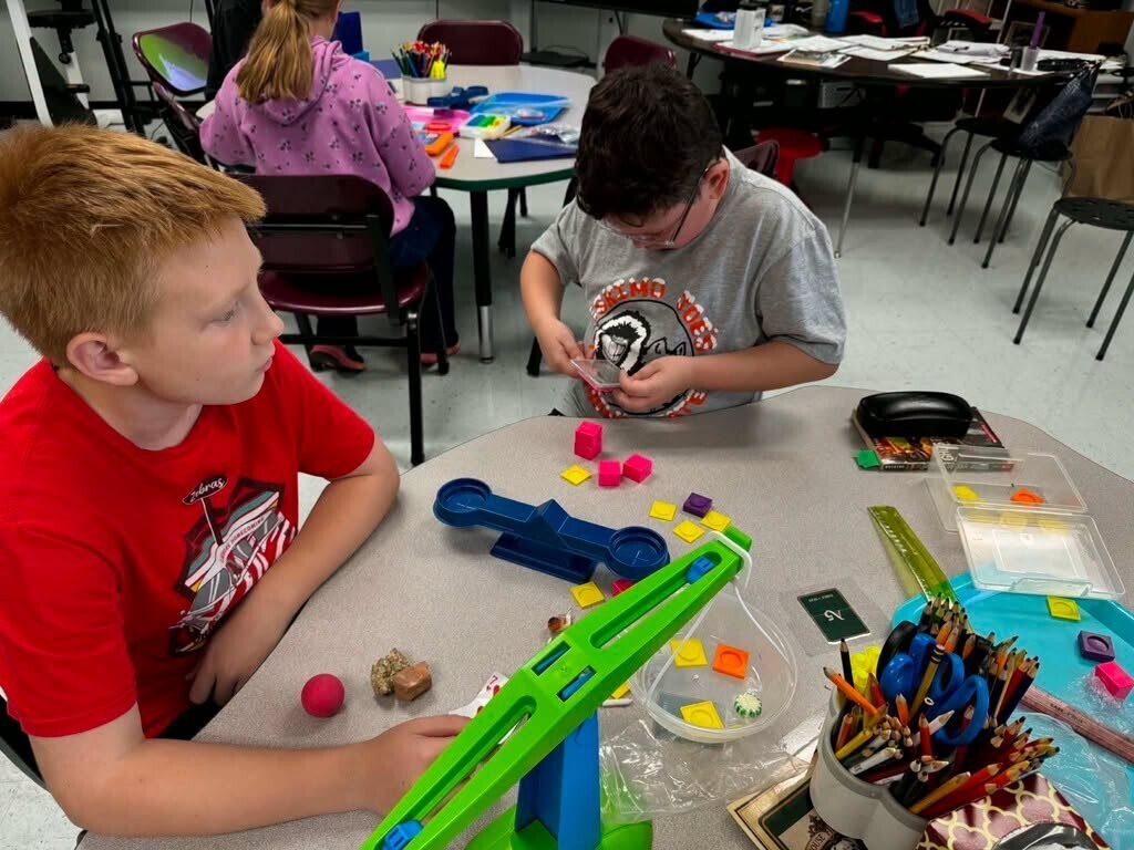 Elementary students doing science experiments in class.