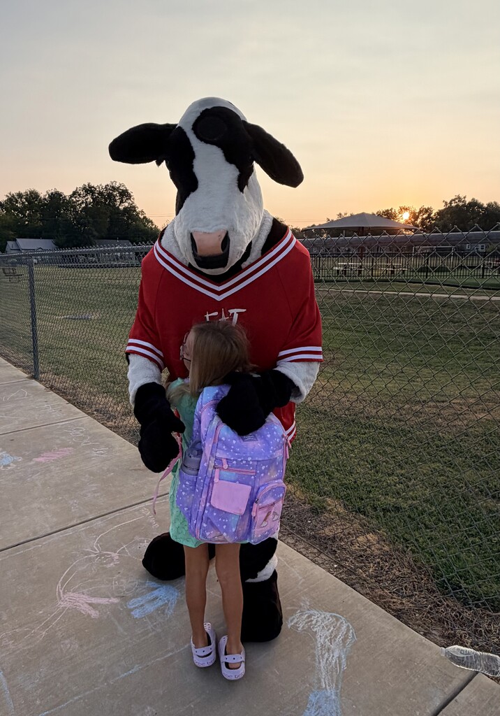 student hugging chick fil a cow