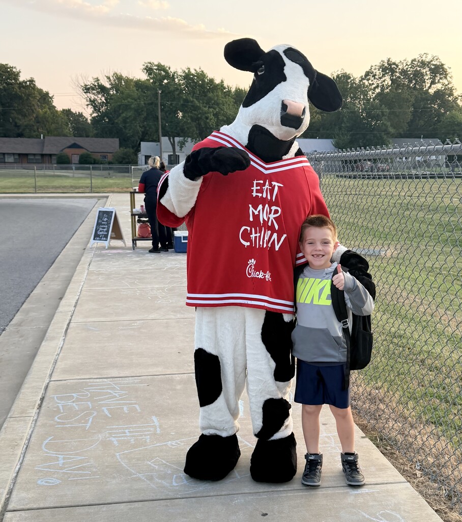 student hugging chick fil a cow