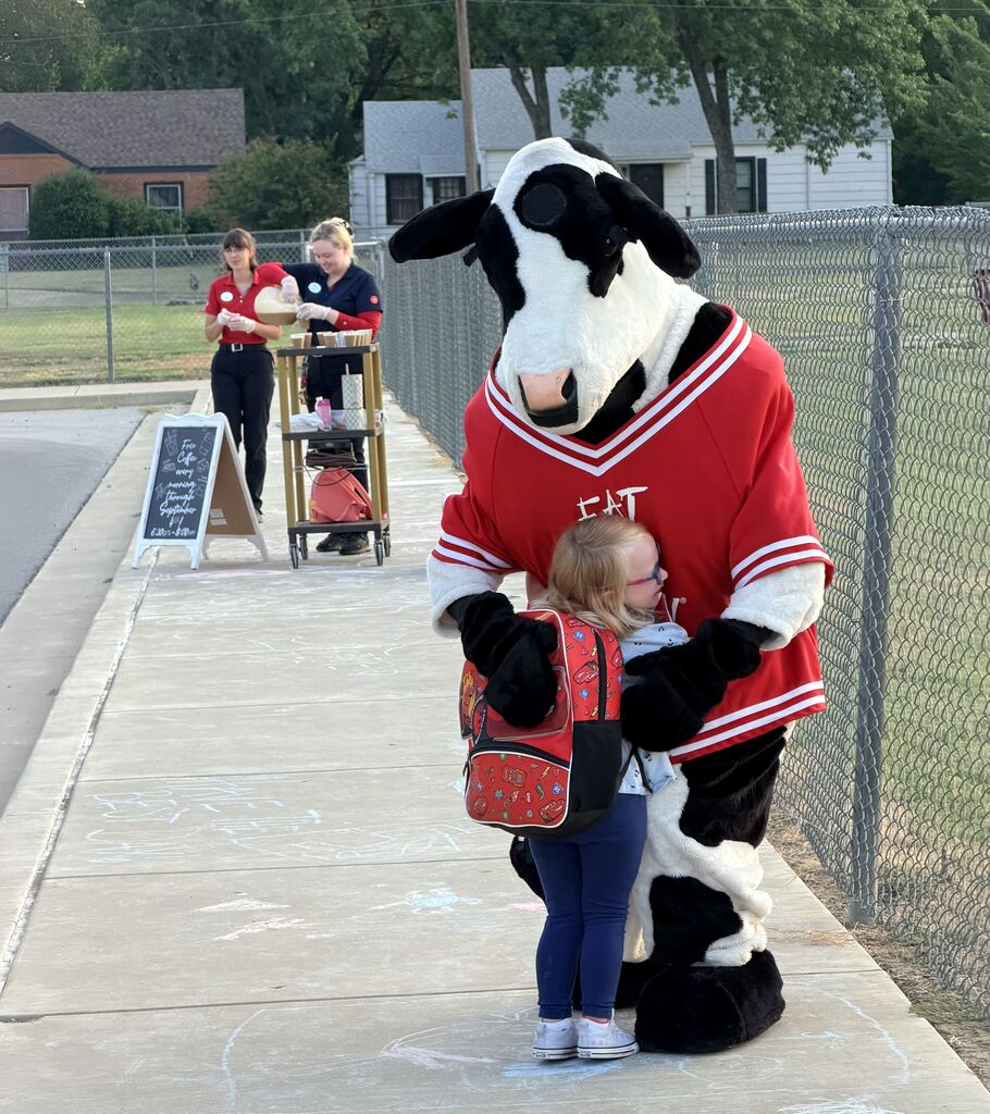 student hugging chick fil a cow