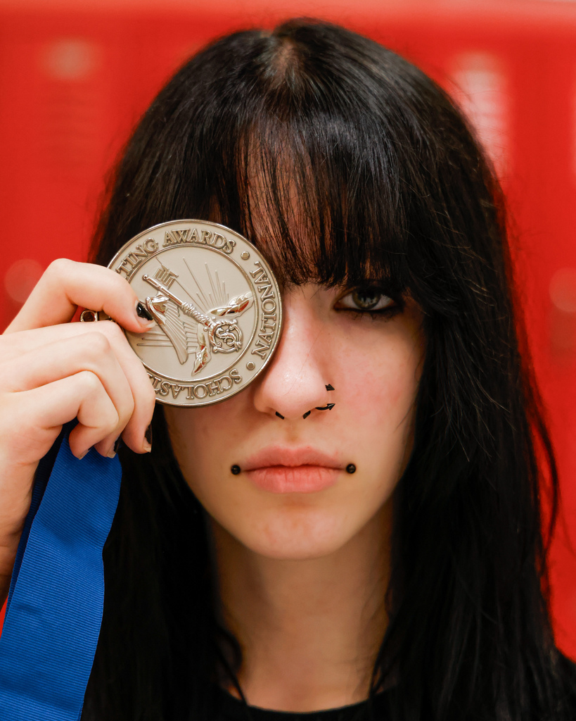 High school art student with her award