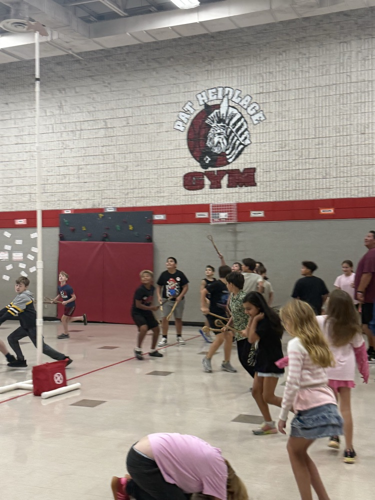 photo of students playing stick ball