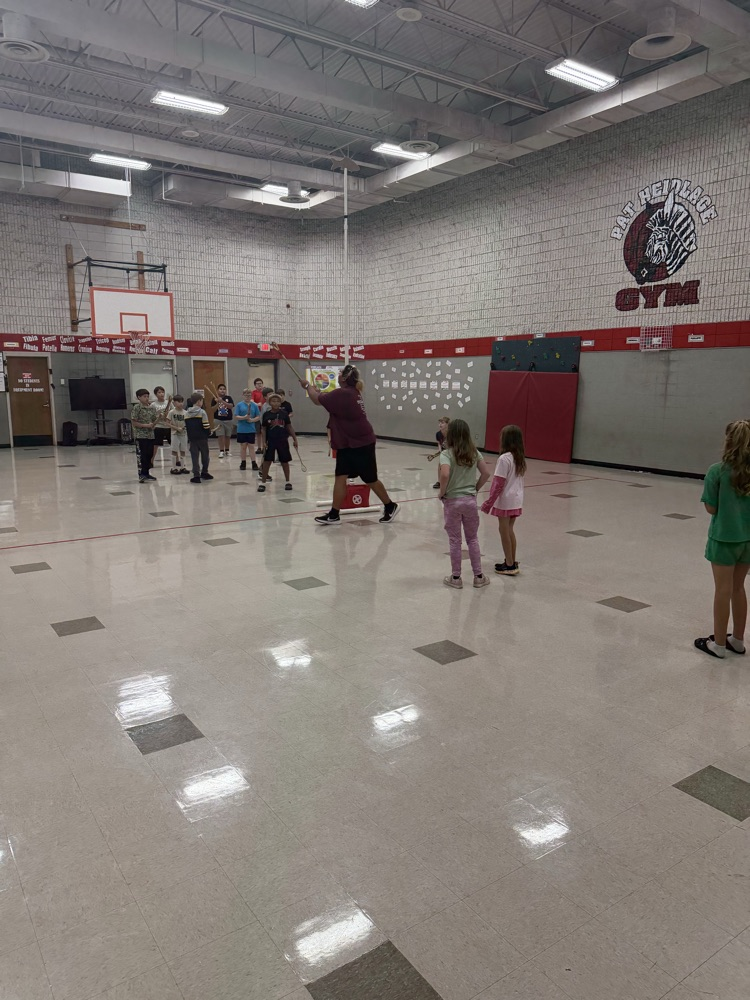 photo of students playing stick ball