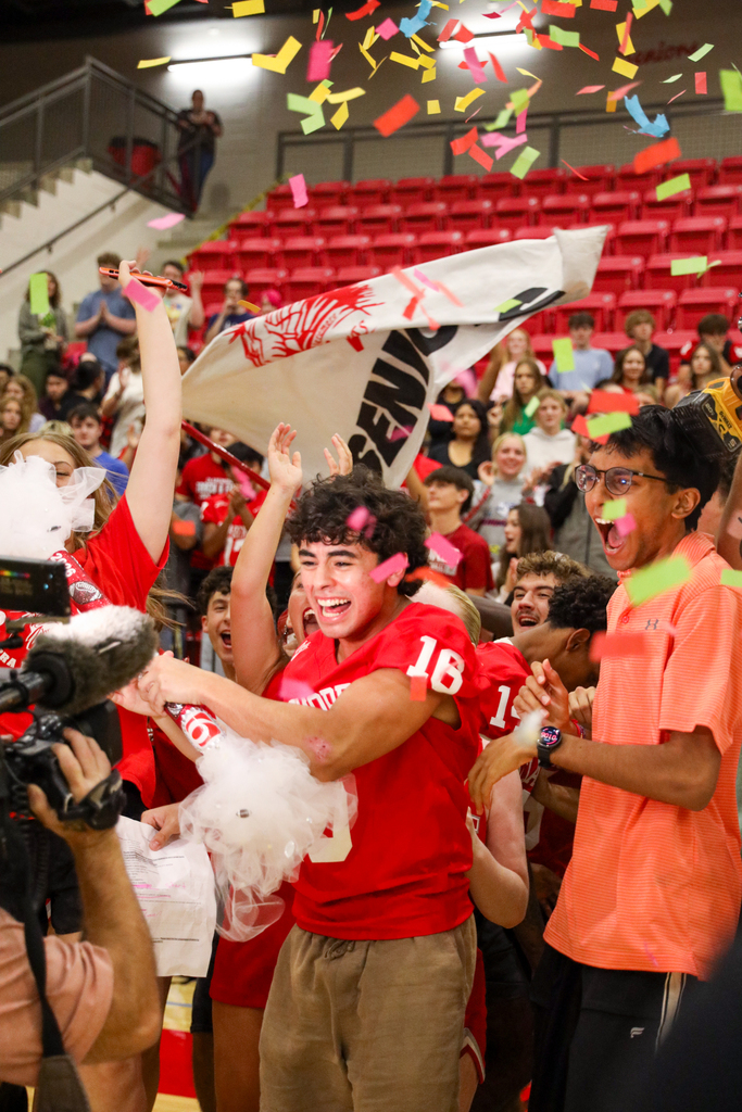 Students cheering for the news channel with spirit stick 