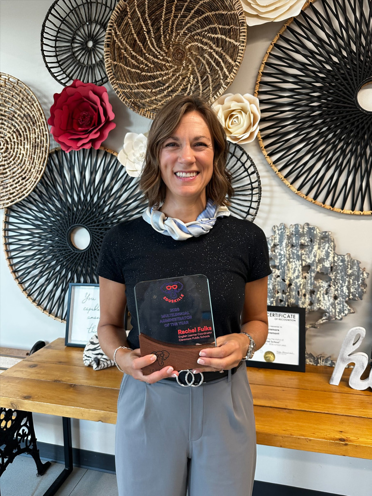 teacher holding plaque