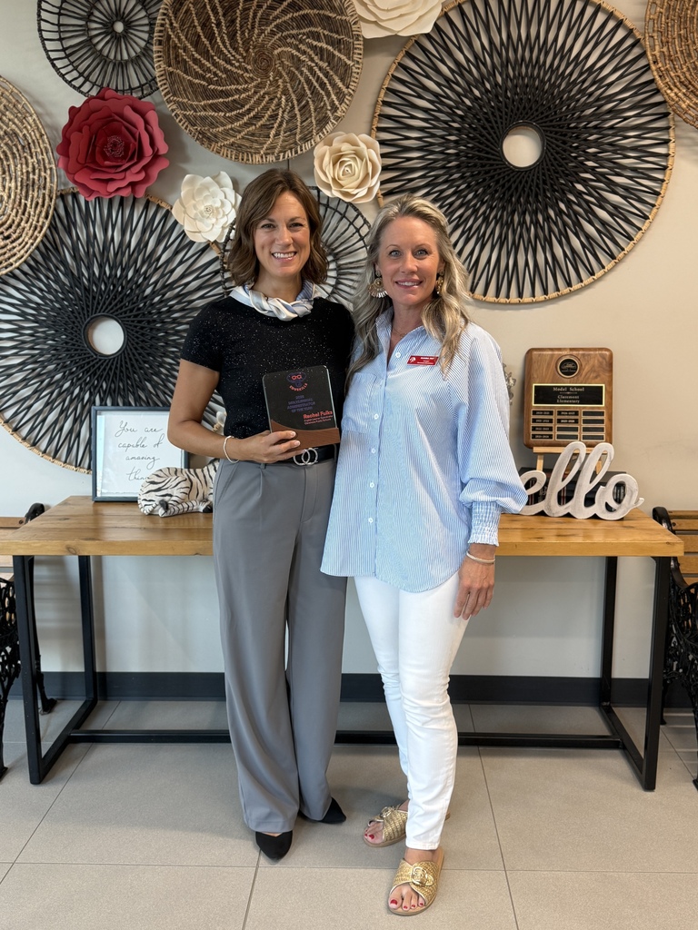 teacher and admin holding plaque and smiling