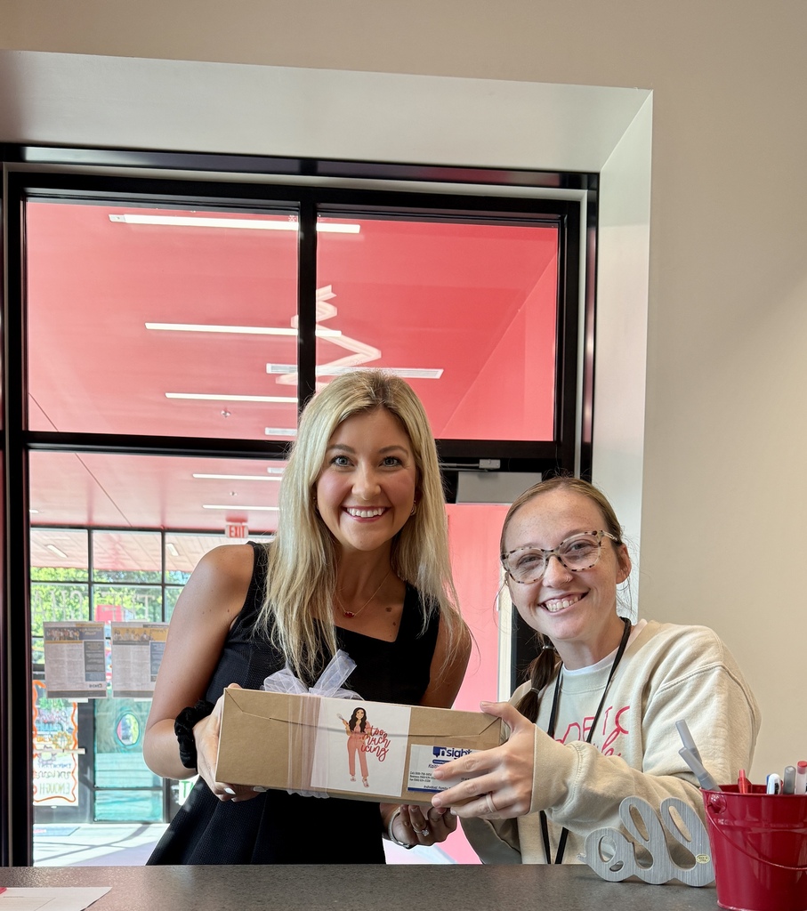 staff and new counselor holding cookies 