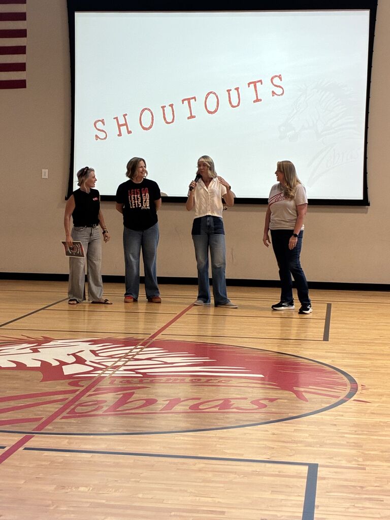 Four teachers standing up front
