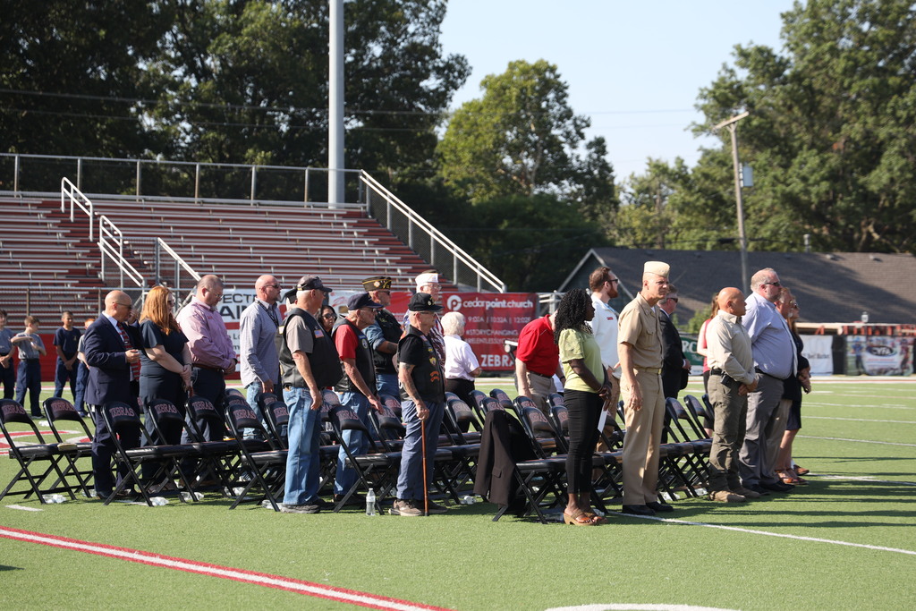 Veterans seated on the field 