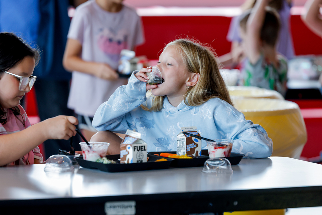 Elementary student enjoying squid ink pasta.