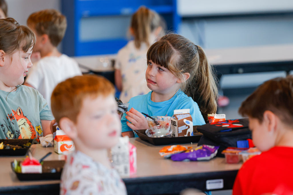 Elementary student unsure by the sight of squid ink pasta.