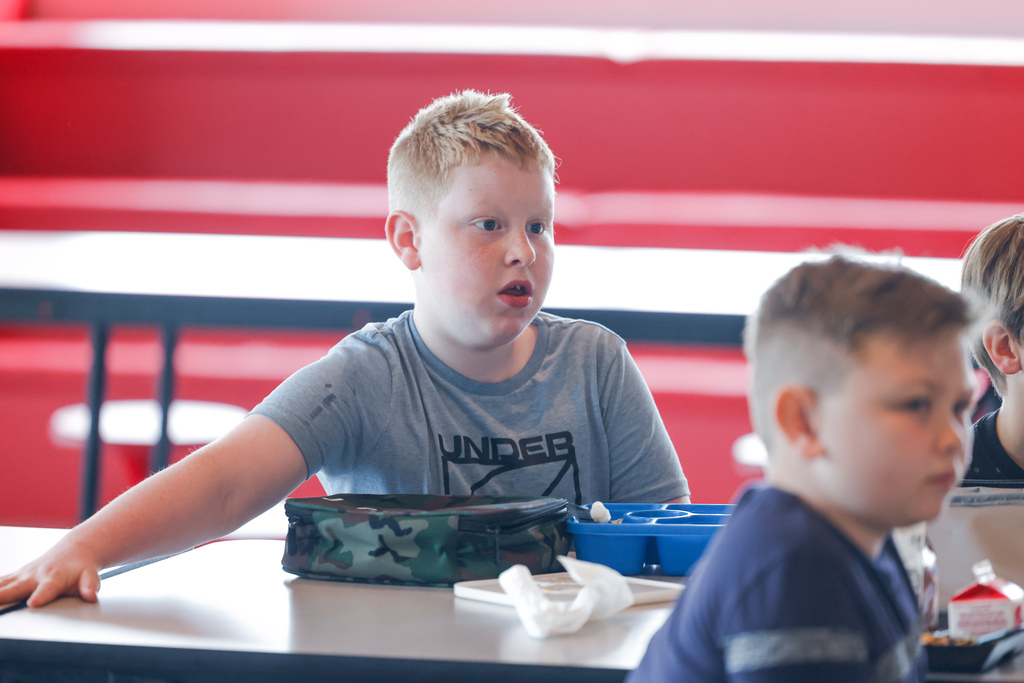 Elementary student shocked at the sight of squid ink pasta.