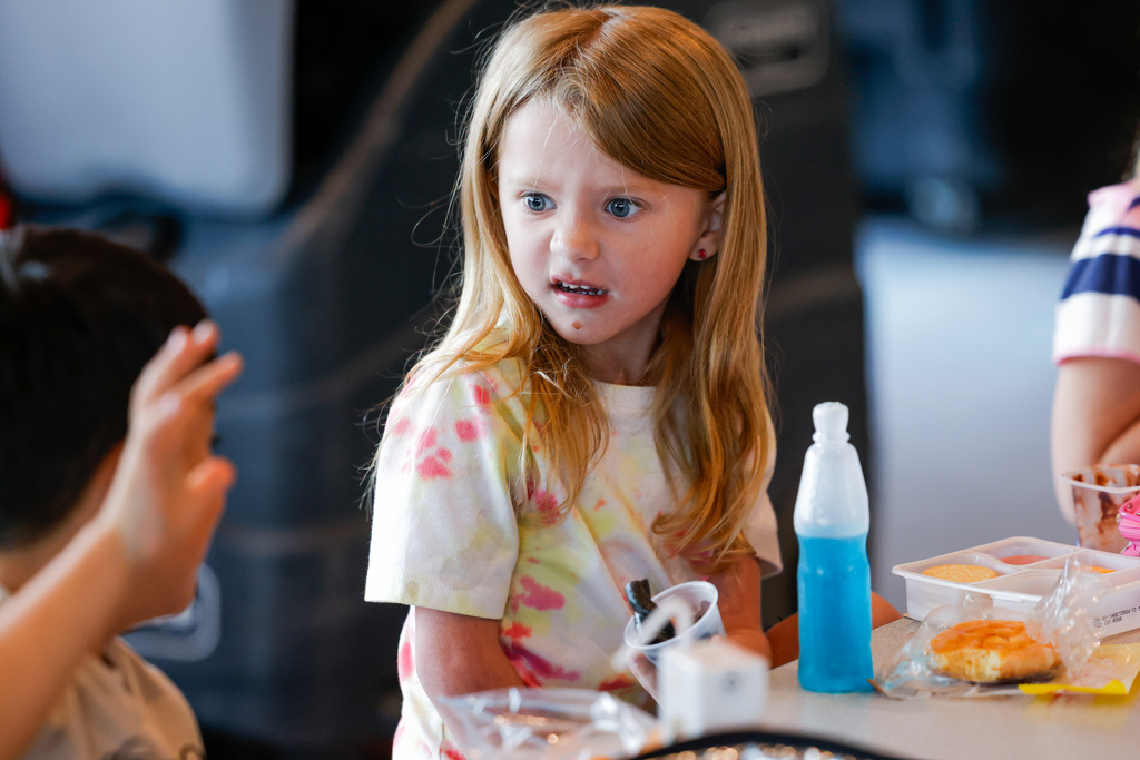 Elementary student shocked at the sight of squid ink pasta.