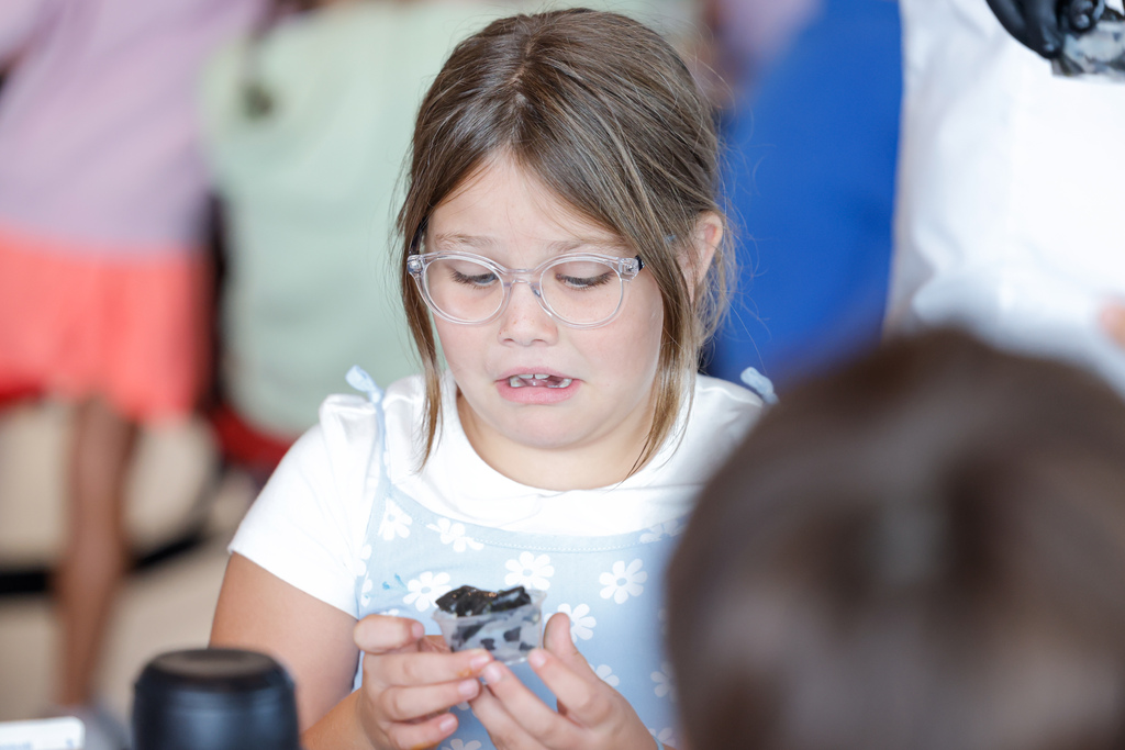 Elementary student disgusted by the sight of squid ink pasta.