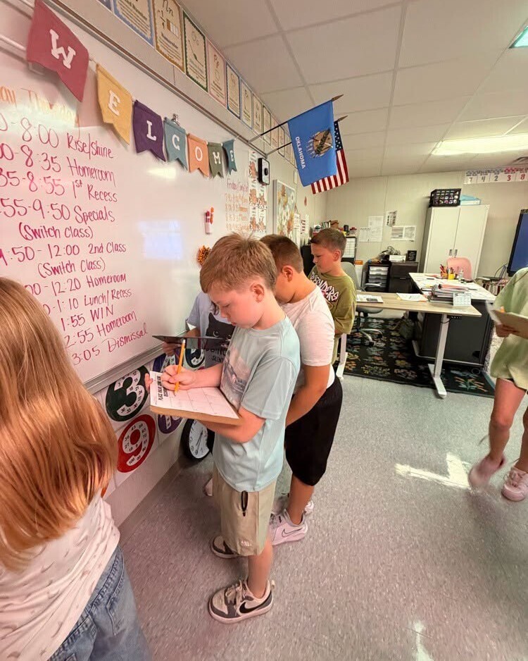 Elementary students working to solve math activity.