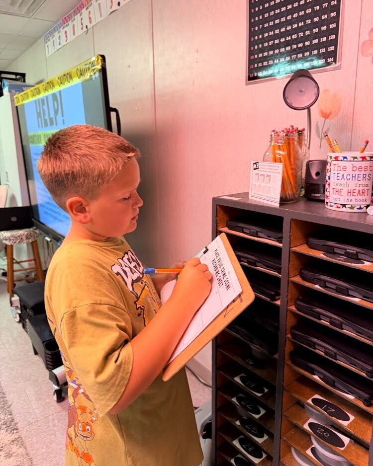 Elementary students working to solve math activity.
