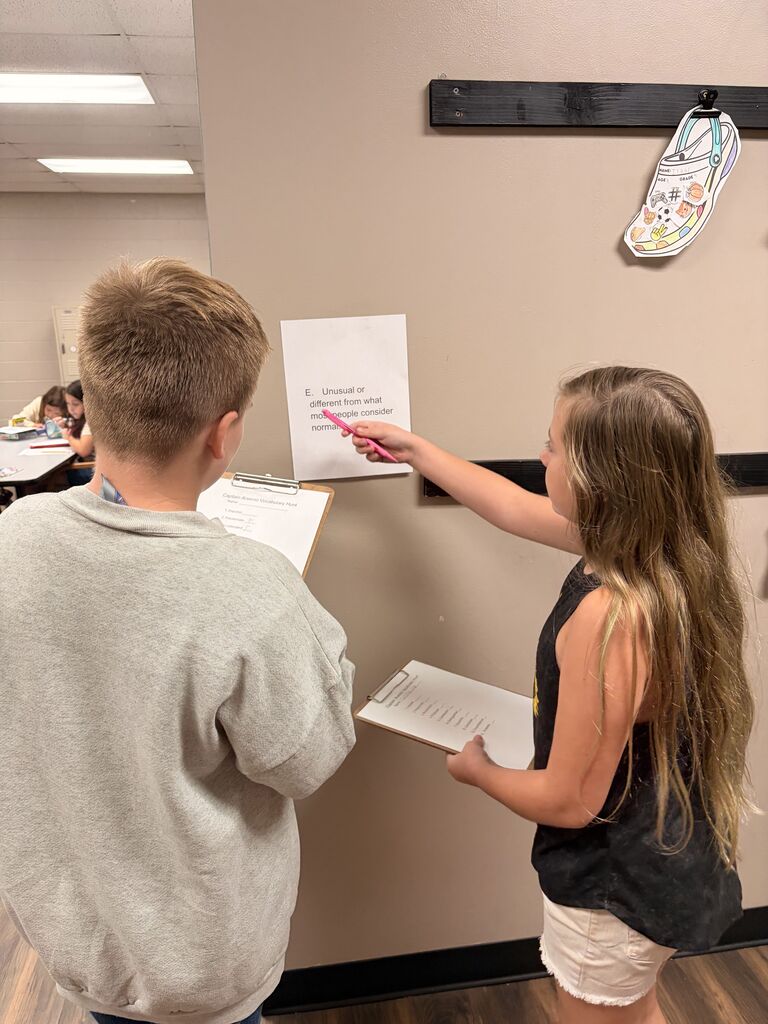 students looking at scavenger hunt paper