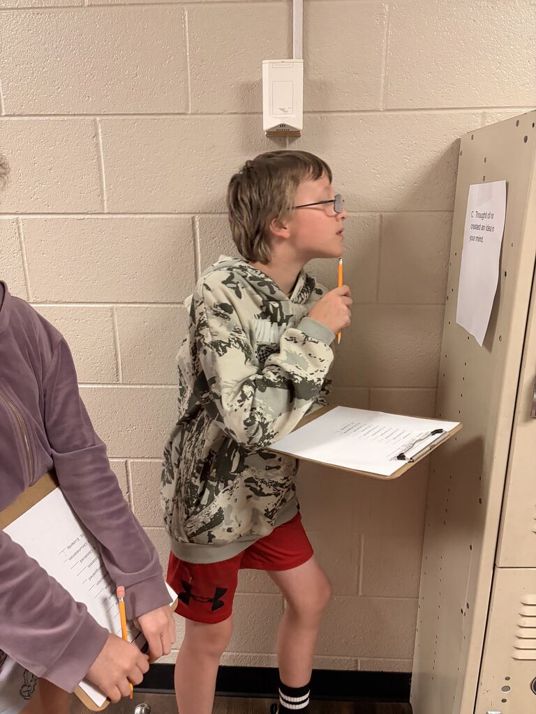 student looking at scavenger hunt paper