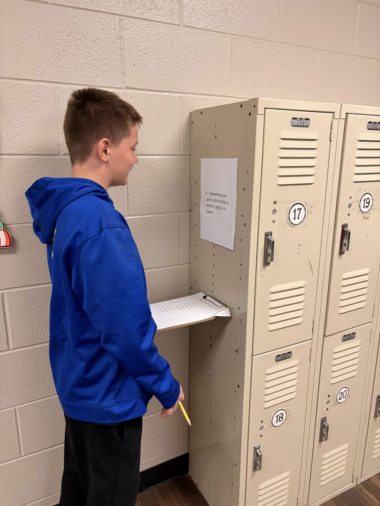 student looking at scavenger hunt paper