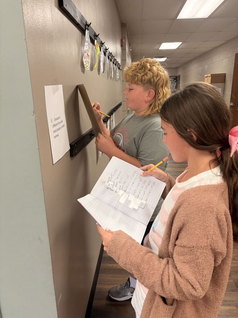 students looking at scavenger hunt paper