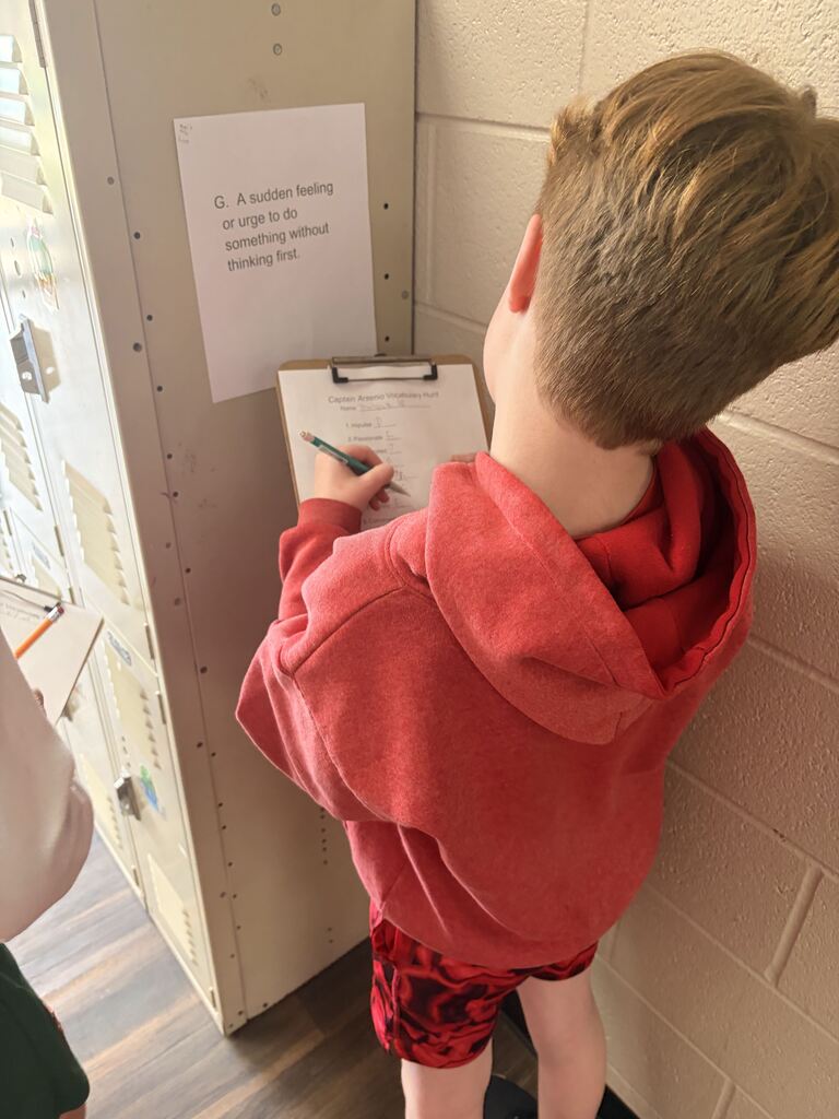 student looking at scavenger hunt paper