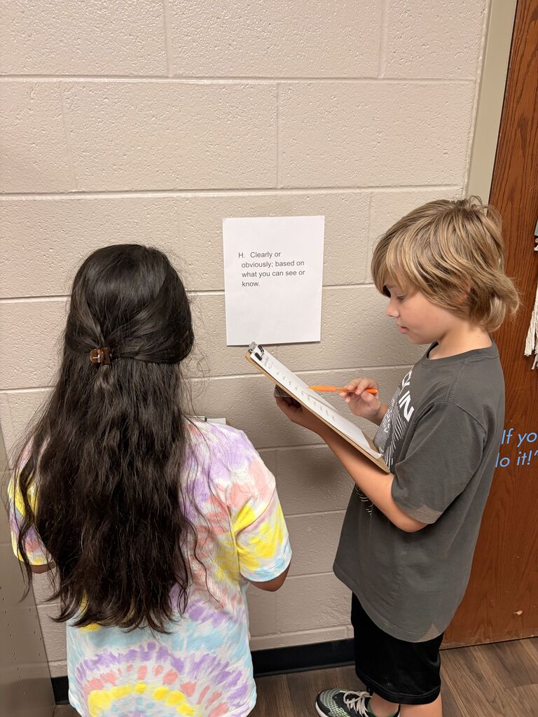 students looking at scavenger hunt paper