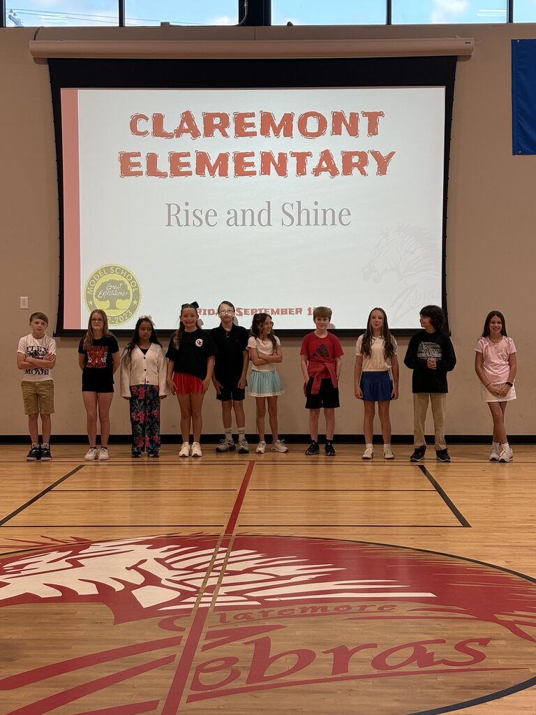 10 students standing at the front of the gym