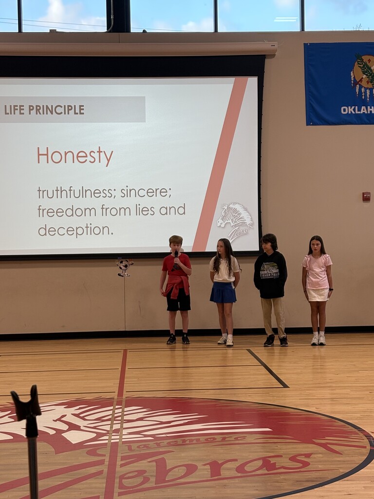4 students standing in fornt of the gym