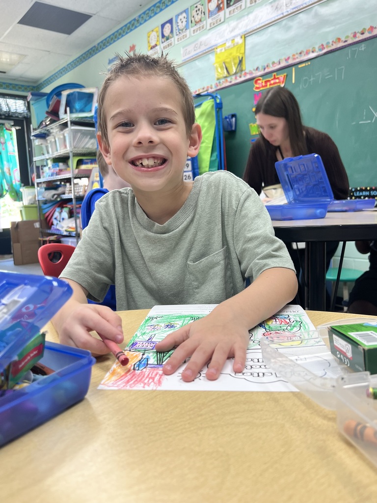 student coloring and smiling