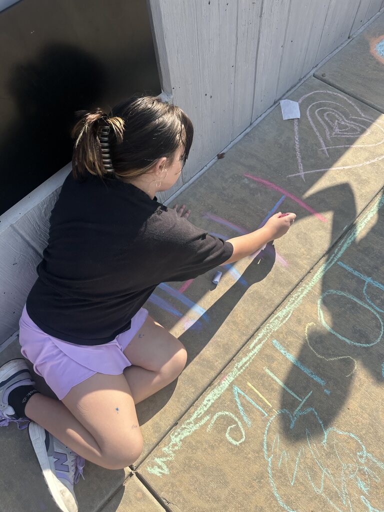 student coloring with chalk