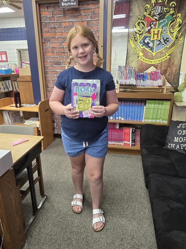 student holding book