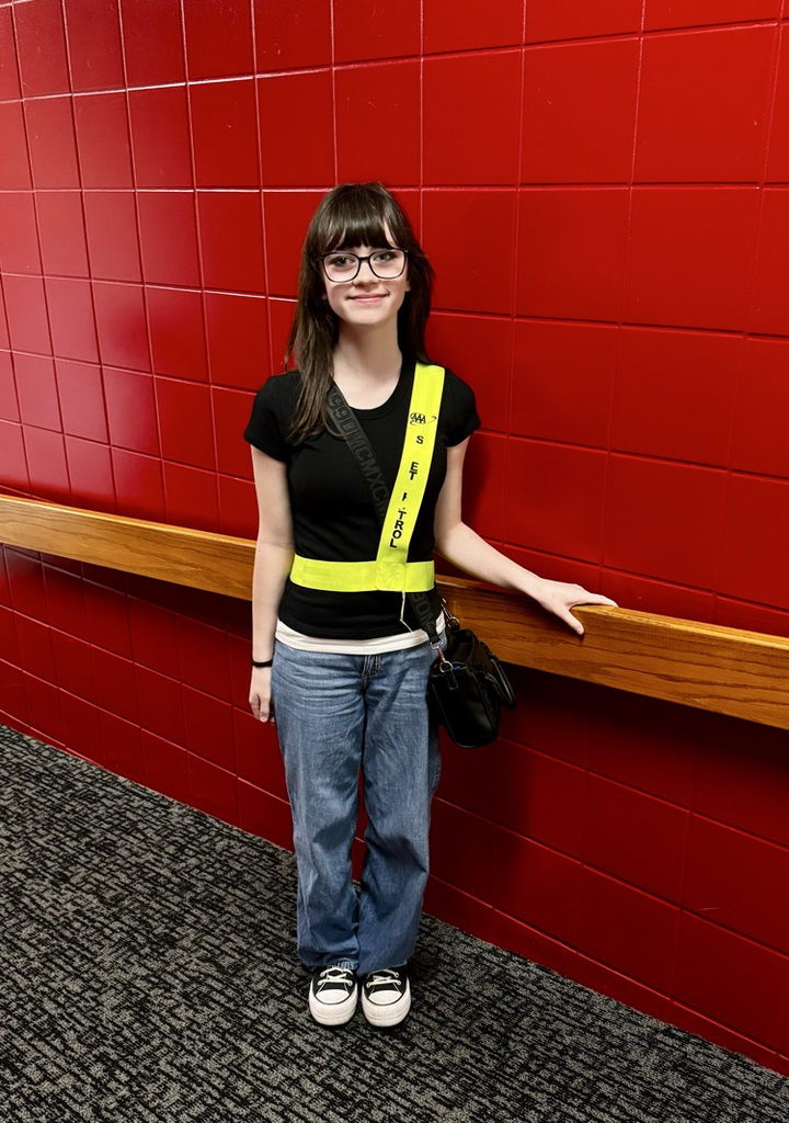 student in safety sash 