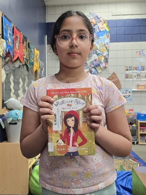 student holding book