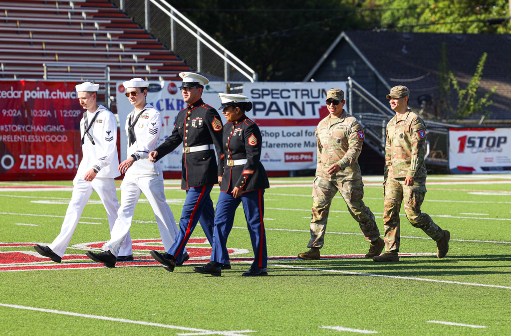 Members of Navy, Marines and Army walking 