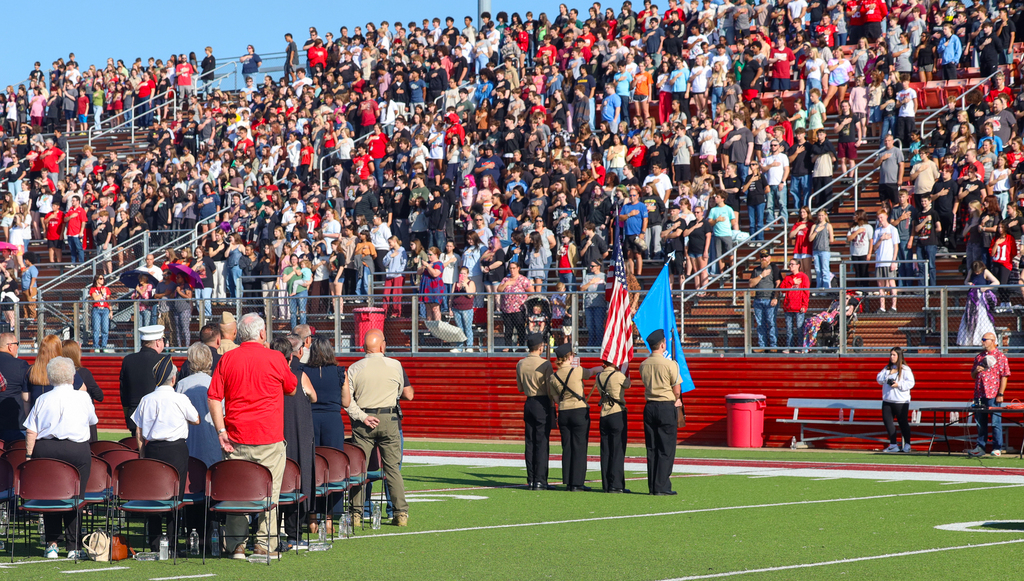 NJROTC members holding flags during National Anthem and whole crowd