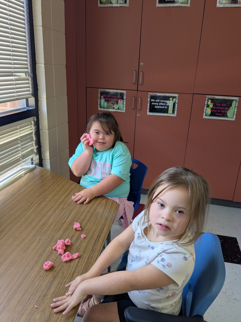Students smiling with playdoh