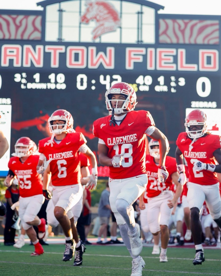 Football players running on the field. 