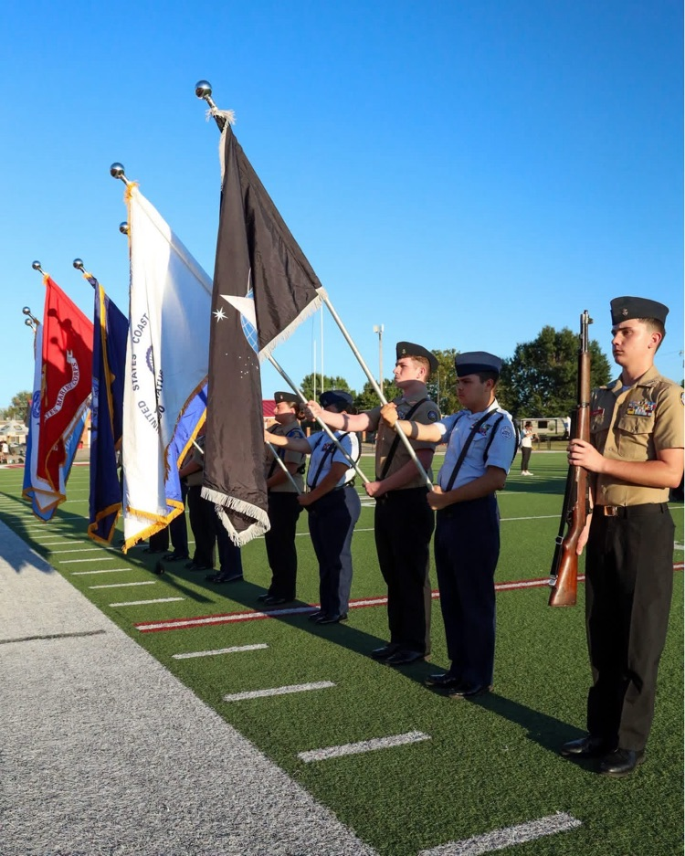 ROTC with flags on sideline.