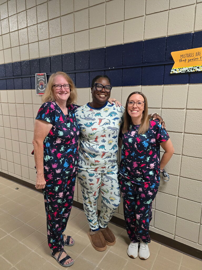 staff smiling wearing pjs to school