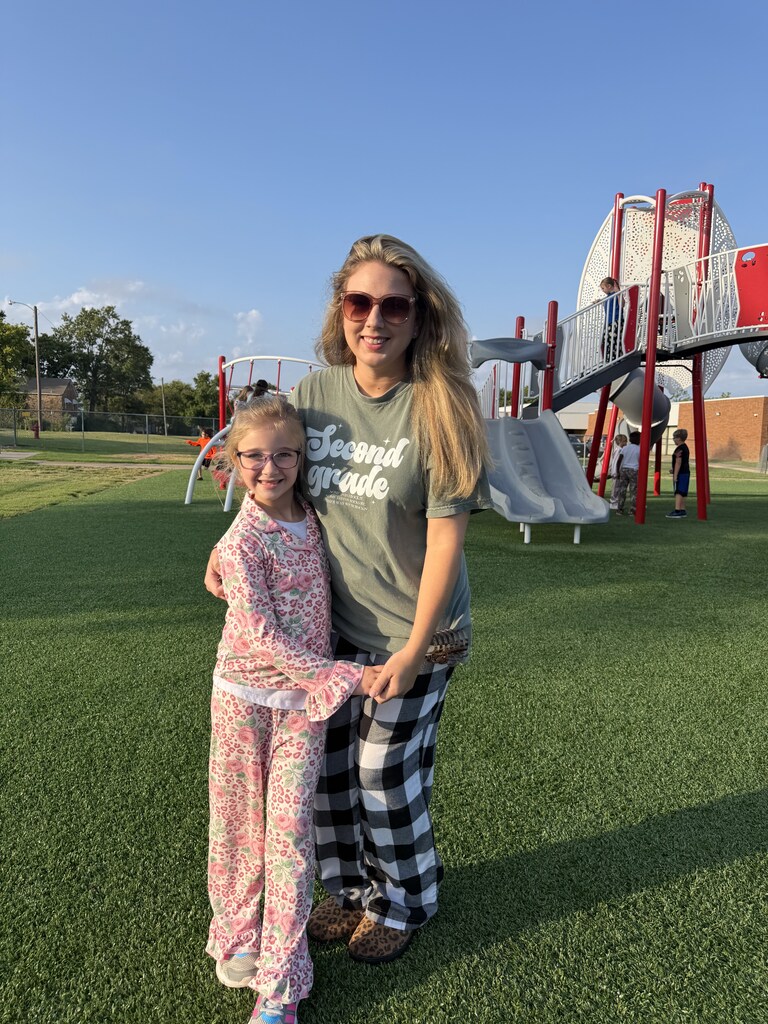 student and teacher smiling wearing pjs to school