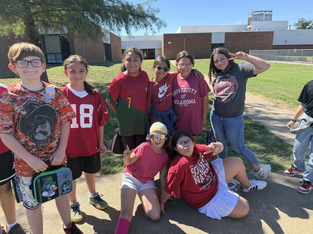 students smiling in lots of different sport teams