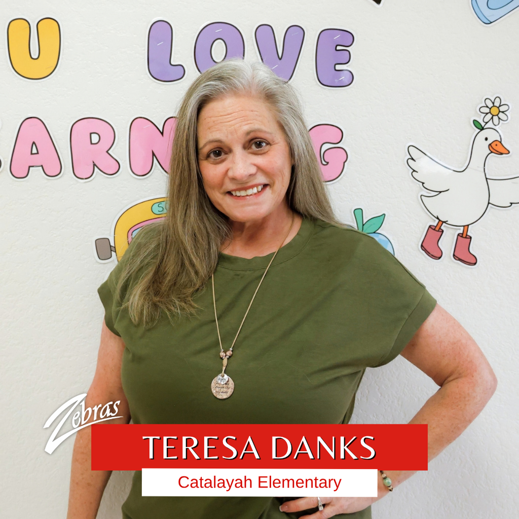 Mrs. Danks in front of a bulletin board