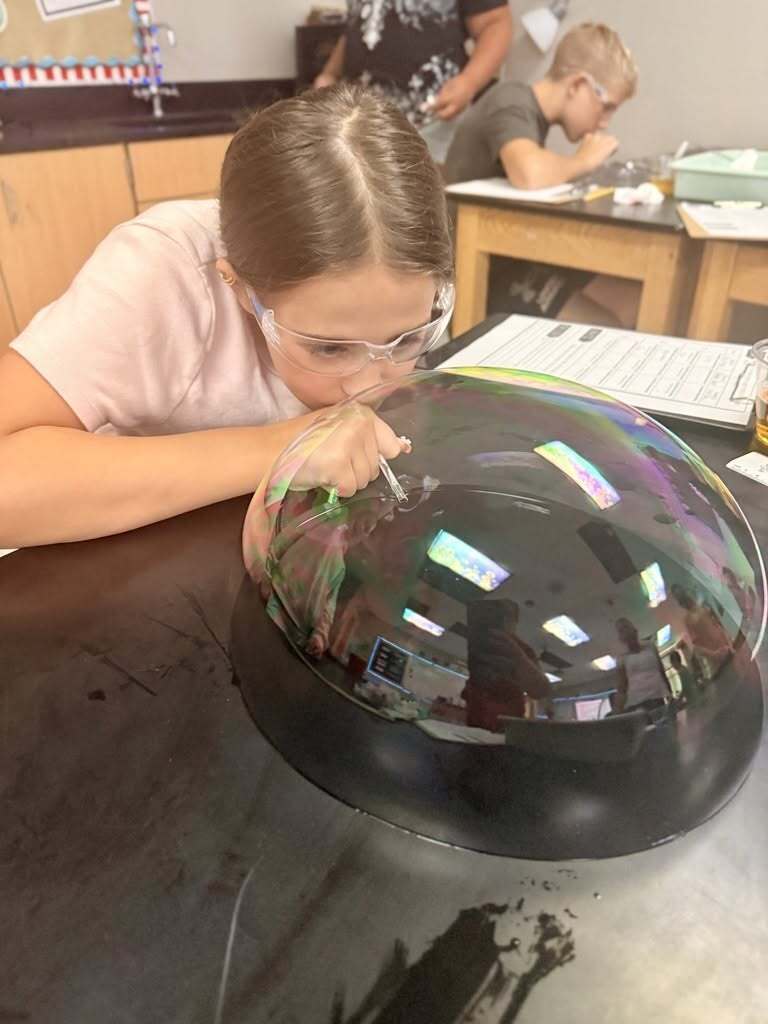 Student creating a buttle on the lab table.