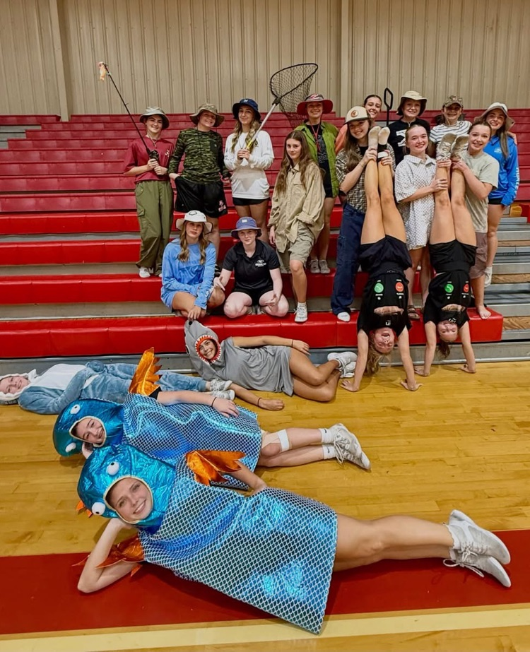 Cheerleaders in shark & fishing costumes. 