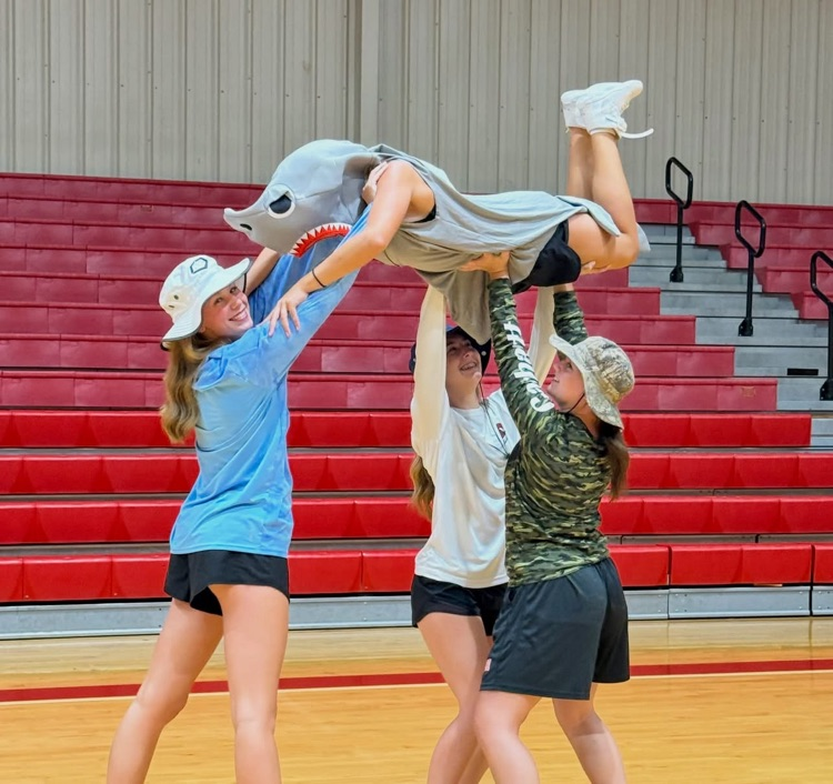Cheerleaders in shark & fishing costumes. 