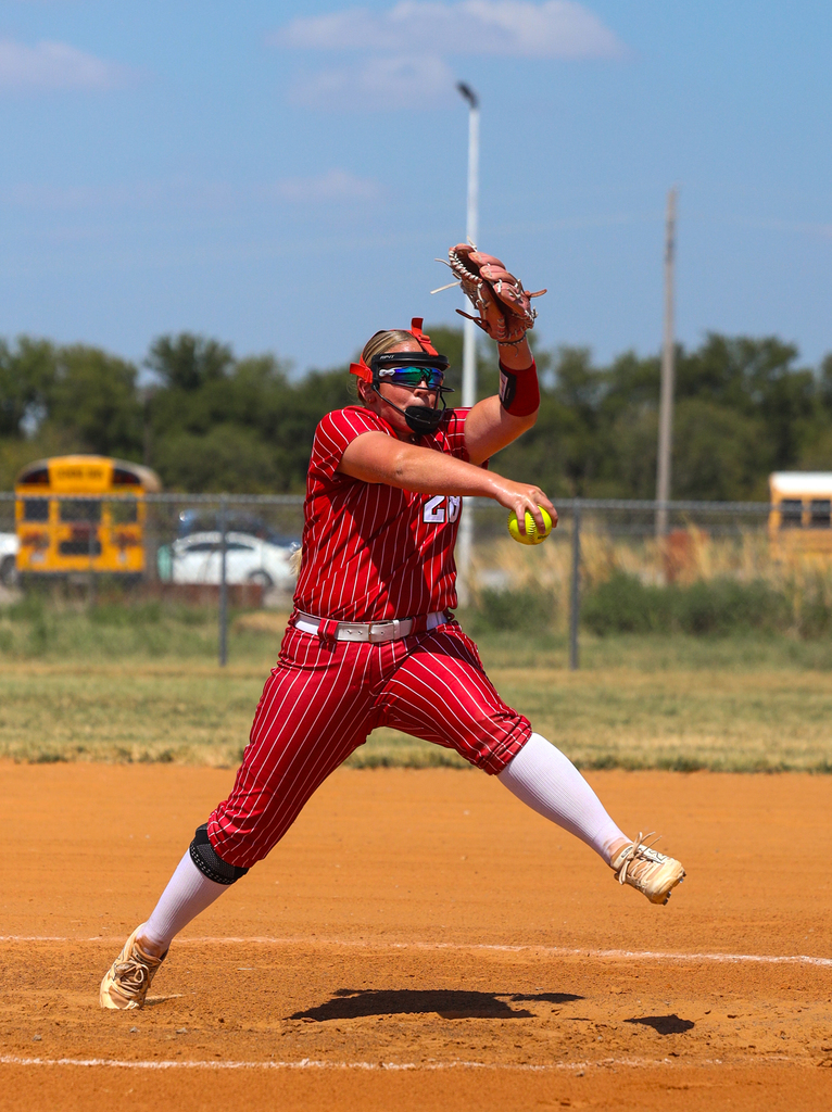 Softball player pitching 